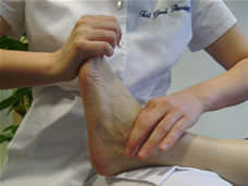 A Bowen move being applied to a patient's ankle