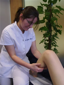 A Bowen practitioner performing moves on the calf.