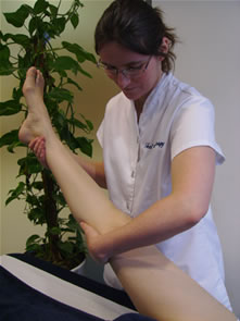 A client's leg is being slowly lowered after a Bowen move has been performed.
